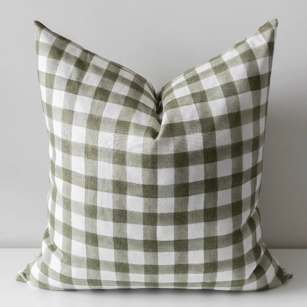 A square throw pillow with a classic green and white gingham checkered pattern, photographed against a neutral light gray background.