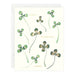 Card with four-leaf clover illustrations and text on a white background
