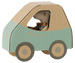 A small plush mouse toy driving a handmade cardboard car. The car features a light teal green side panel, a natural brown cardboard roof and wheel centers, and dark gray wheels.