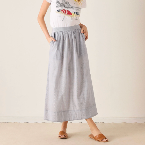 Person wearing a light gray skirt with a white background