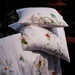 Floral-patterned pillow and duvet set on a dark background
