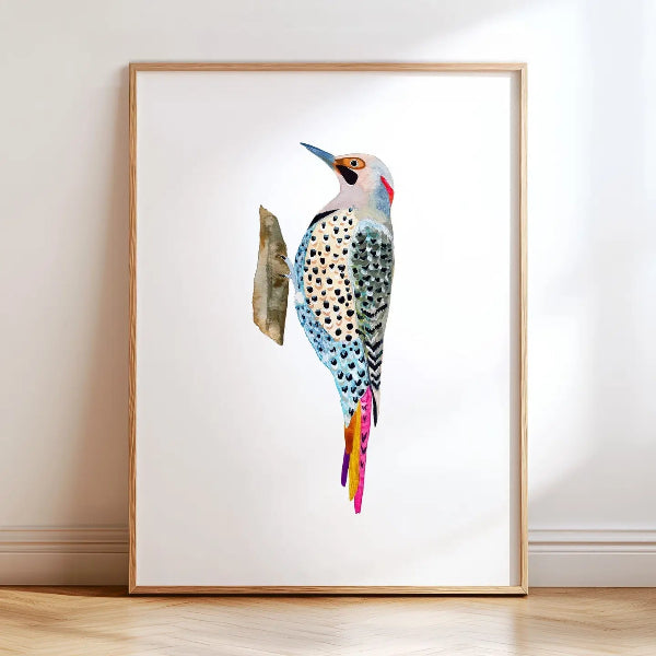 Framed artwork of a colorful bird on a white wall.