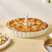 Pie with a rabbit-shaped pie bird on a yellow table