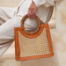 Brown woven handbag held by a person wearing a white outfit on a light background