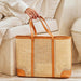 Person holding a woven basket with brown handles on a light-colored couch.
