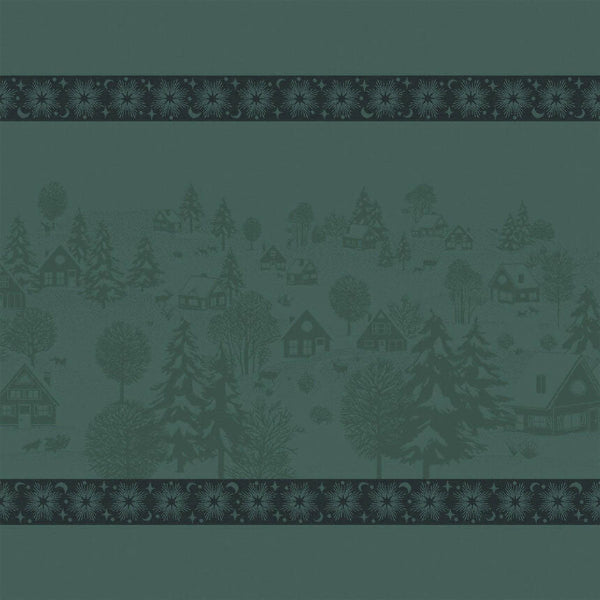A repeating fabric or wallpaper pattern in muted teal-green, featuring a central winter village scene with trees, cabins, and small animals, framed by decorative borders at the top and bottom.