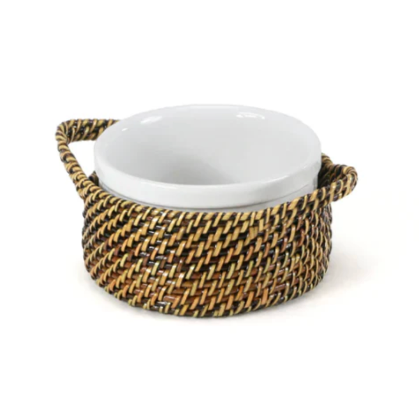 White ceramic bowl with woven brown handle on a white background