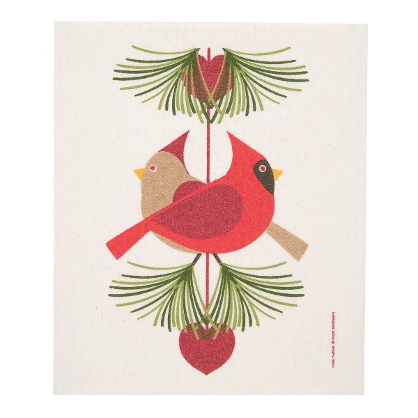 A sswedish dishcloth featuring a stylized folk-art design of two cardinals perched among green pine branches and red heart-shaped ornaments on a cream background.