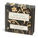 Box of 'Twenty Minute Candles' with decorative gold designs on a black background