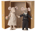 Two toy mice, one in a wedding dress and the other in a suit, standing in front of an ornate box.