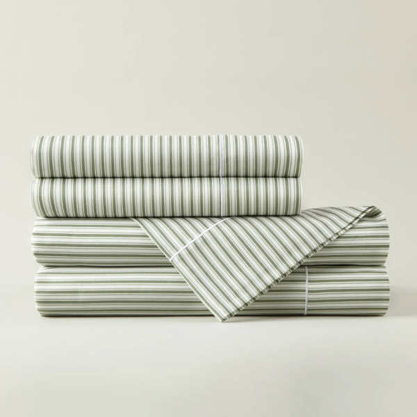 Stack of striped bed sheets on a light gray background